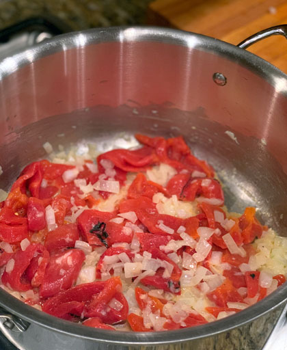 roasted red pepper, onion and garlic simmering in pot.